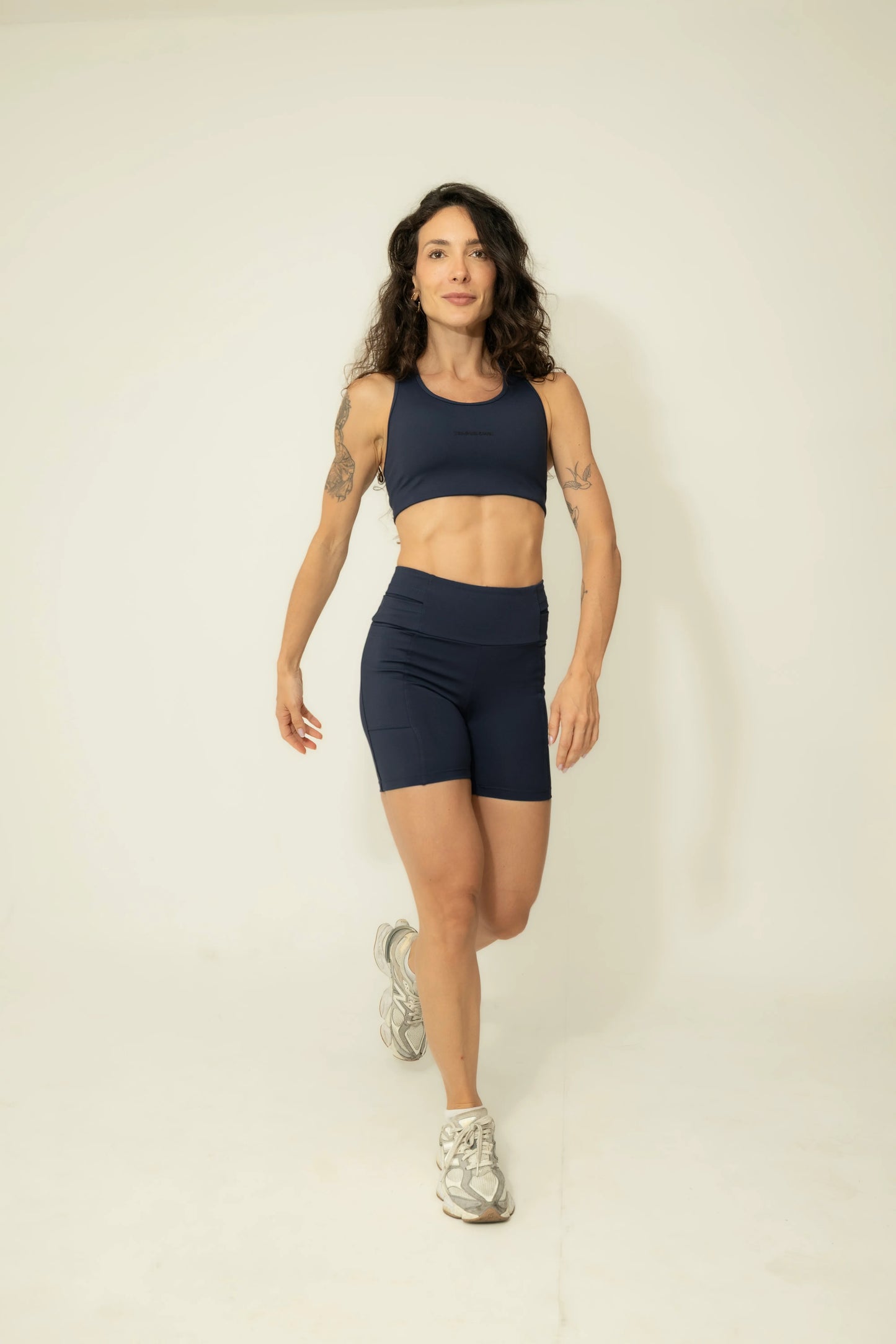 Front view of the Deep Blue high-impact running sports bra, featuring smooth Emana fabric and a supportive athletic fit for high-performance training.