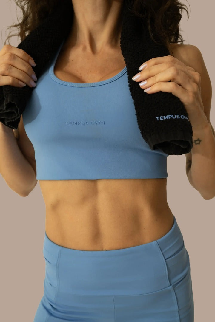 Front close-up of the Caravela Blue running sports bra by Tempus Own, featuring a supportive athletic fit and premium smooth Emana fabric.