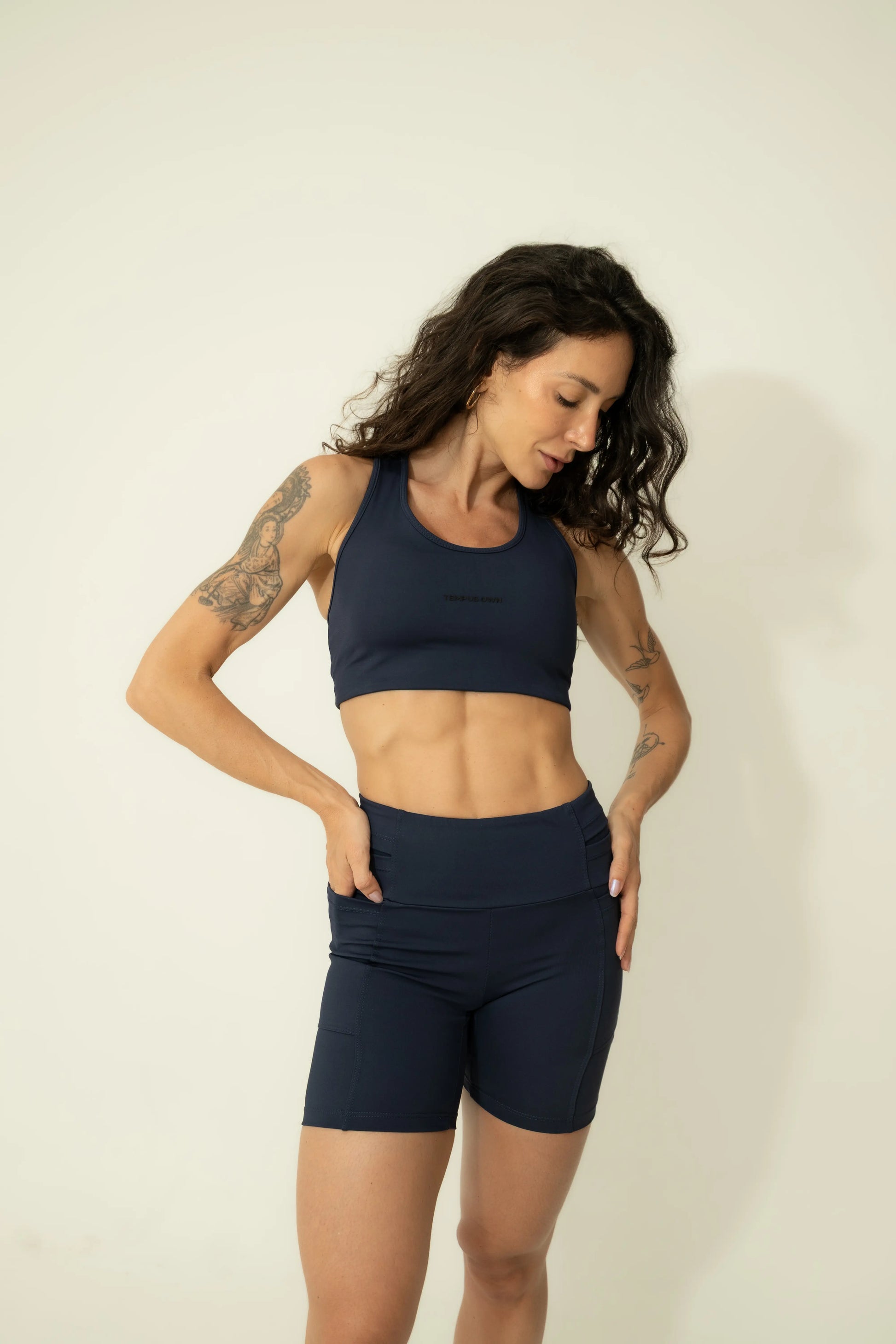 Front view of Deep Blue high-waisted running shorts, featuring deep side pockets specifically designed for nutrition, hydration, and phone storage.